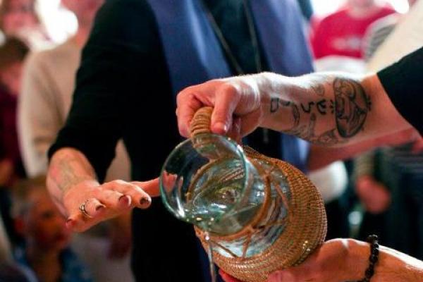 The hands of the author and ordainee, Matthew Nickoloff, in the baptismal font. 