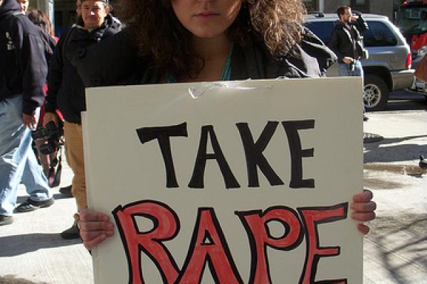 Protester holding placard, 2010. Image via Wylio. http://bit.ly/rXM1Om