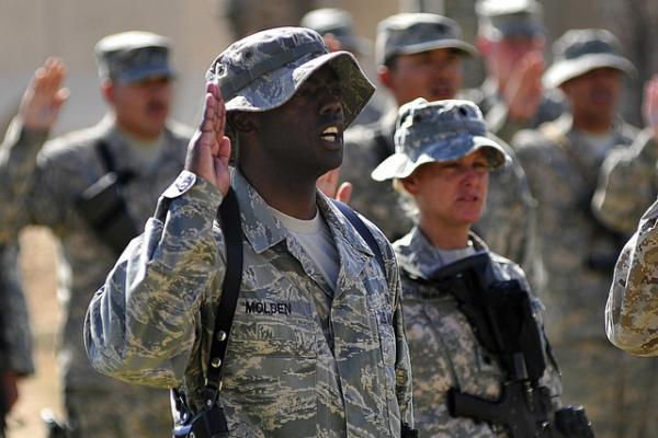 Tech. Sgt. LaMarcus Molden recites the oath of enlistment at Al Asad Air Base in