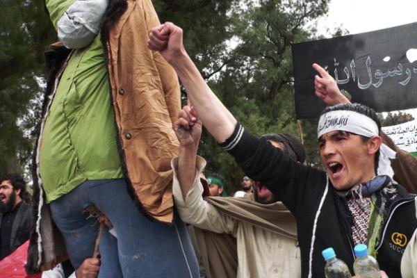 Demonstrators carry effigy of President Obama during a protest of a US soldier's