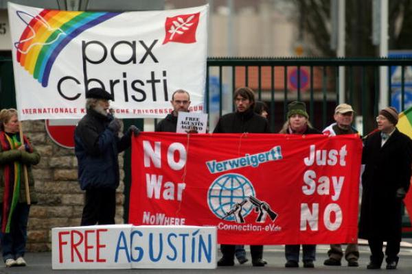 Conscientious objectors rally in Germany. Image via Getty Images.