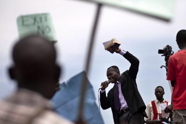 Man holding Bible speaks during anti-homosexuality rally in Kamapala, Uganda 