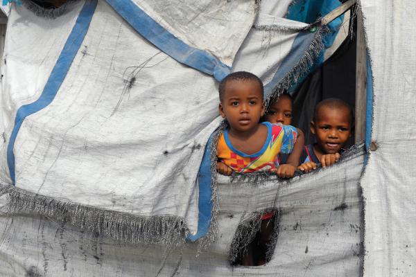 Children in a tent, Haiti 2014. Image courtesy Chuck Bigger, Compassion Internat