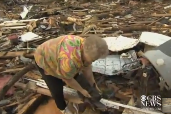 Screenshot of woman who found her dog amid tornado rubble in Moore, Okla.