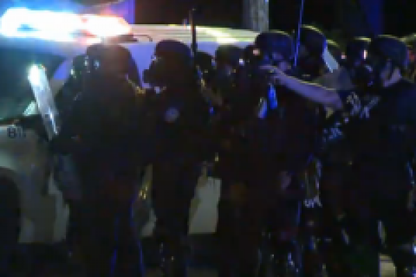 Police march in Ferguson. Image courtesy RNS.