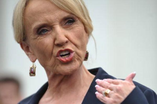 Arizona Gov. Jan Brewer speaks to reporters in 2010. Photo via Getty Images. 