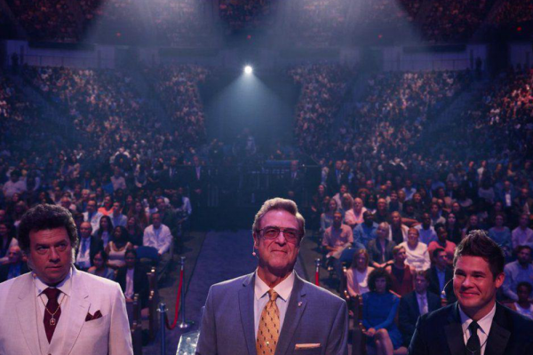 The main characters in 'The Righteous Gemstones' stand on a stage surrounded by a large crowd.