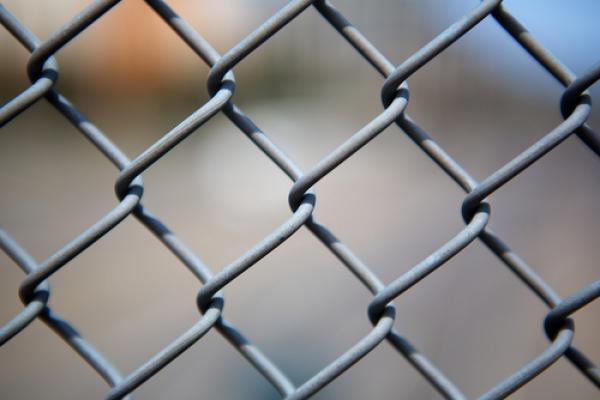 Chain link fence. Image courtesy Bobkeenan Photography / shutterstock.com.