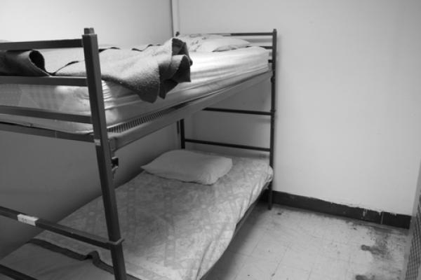 Beds in a homeless shelter, Nathan Kresge / Shutterstock.com