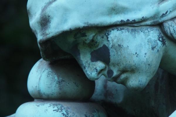 Grave marker showing face of sorrow, Hub.-Wilh. Domroese / Shutterstock.com