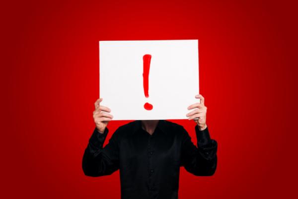 Man Holding Sign Exclamation Eugenio Marongiu / Shutterstock