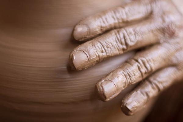  Potter's hands on a wheel, bluelake / Shutterstock.com