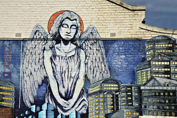 An angel surveys a city. Image courtesy Neale Cousland/shutterstock.com