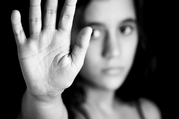 A woman holds up her hand. Image courtesy Kamira/shutterstock.com