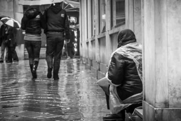 Pedestrians passing by homeless person, uros1210 / Shutterstock.com