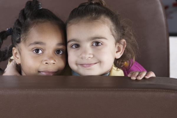 Two young girls on a bus. Image courtesy Blend Images/shutterstock.com.