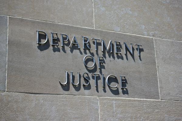 Sign on the exterior of the Department of Justice. Photo courtesy kenkistler/shu