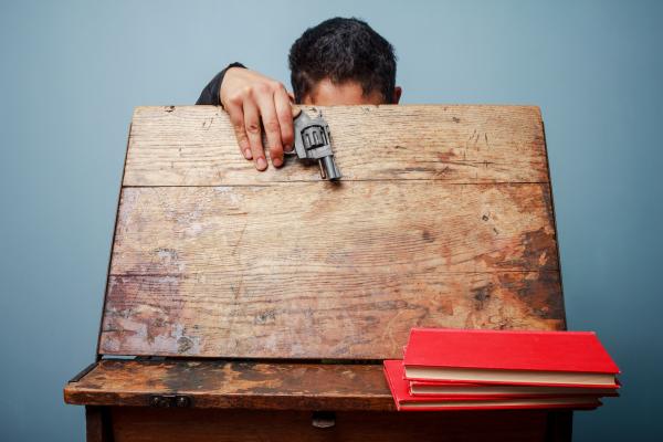 Student with a gun at school, LoloStock / Shutterstock.com