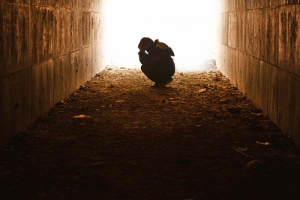 Child alone in a tunnel,  hikrcn / Shutterstock.com