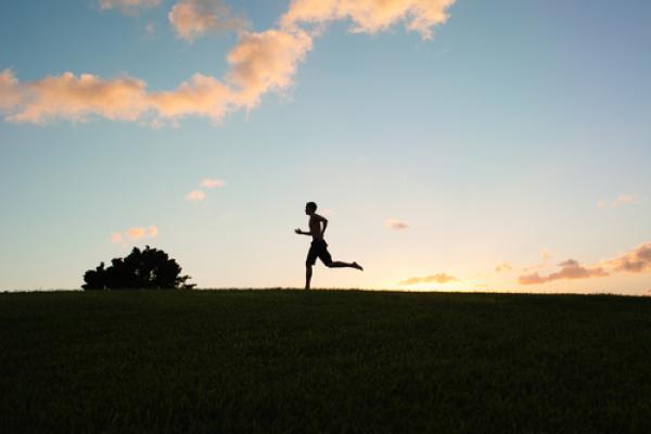Silhouette of young man running, KieferPix / Shutterstock.com