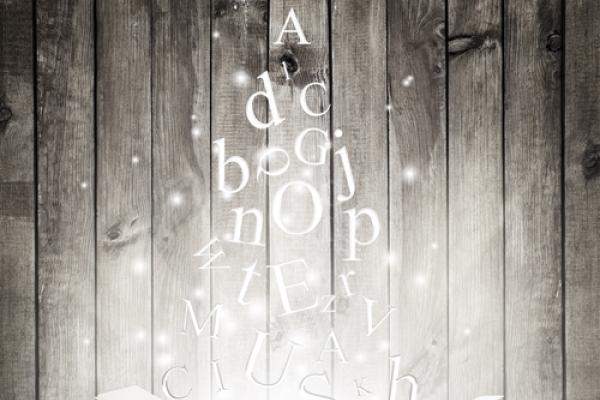 An open book with letters in flight. Image courtesy robert_s/shutterstock.com.