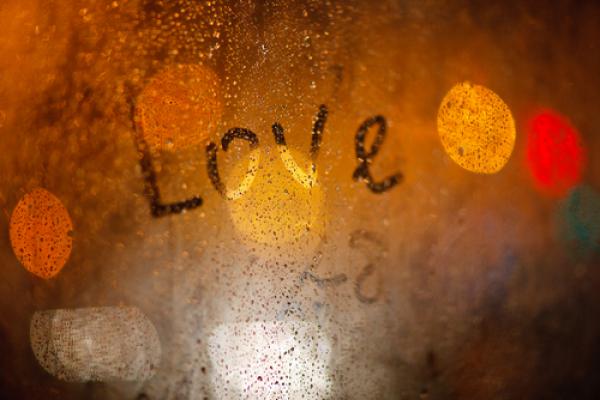 'Love' written on window in the rain, Wolf__ / Shutterstock.com