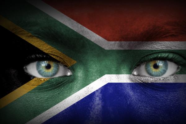 South African flag over human face, Aleksandar Mijatovic / Shutterstock.com