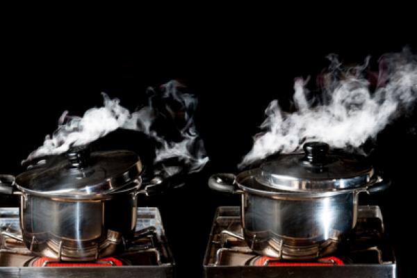 Two pots reach the boiling point. Image courtesy Showcake/shutterstock.com