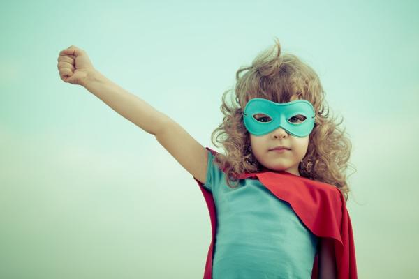 Girl dressed up like a superhero, Sunny studio / Shutterstock.com