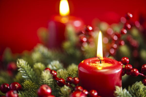An advent candle burns in the wreath. Image courtesy 3523studio/shutterstock.com