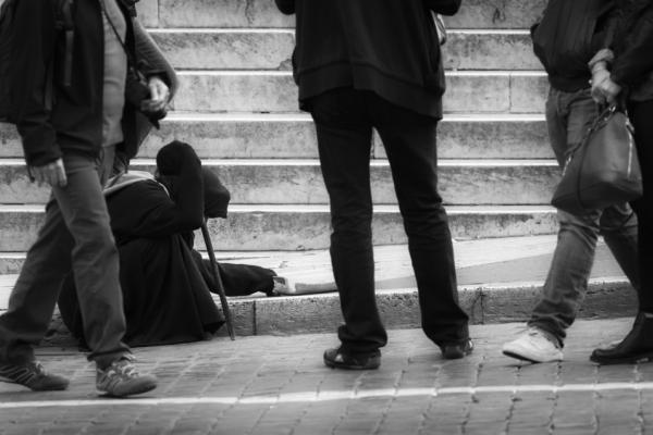 Beggar among a crowd, Lasse Ansaharju / Shutterstock.com