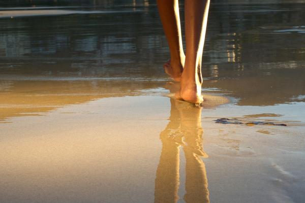 Walking on a beach. Image via mimagephotography/shutterstock.com