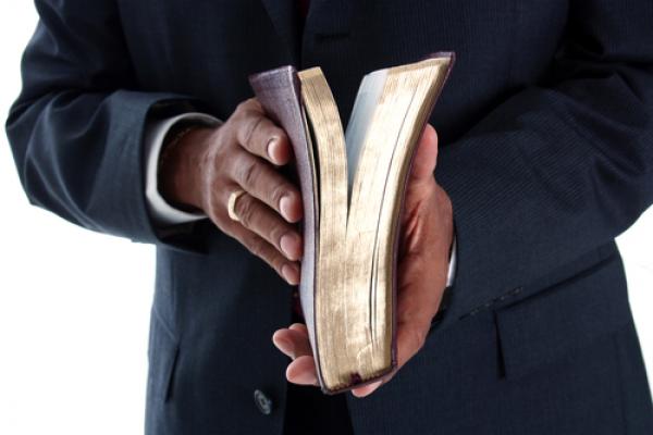 Pastor with Bible, Rob Marmion / Shutterstock.com
