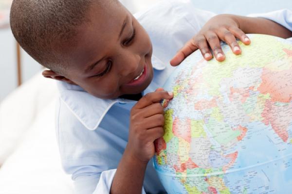 Small boy looking at his globe, wavebreakmedia / Shutterstock.com