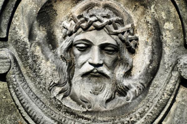 Face of Jesus from an old cemetery statue. Photo by Brasiliao/Shutterstock.com.