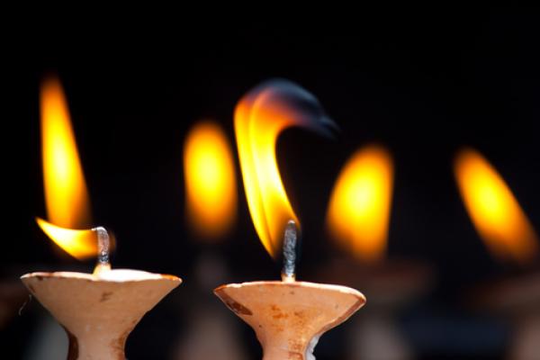 Candles lit at temple. Image courtesy Galyna Andrushko/shutterstock.com