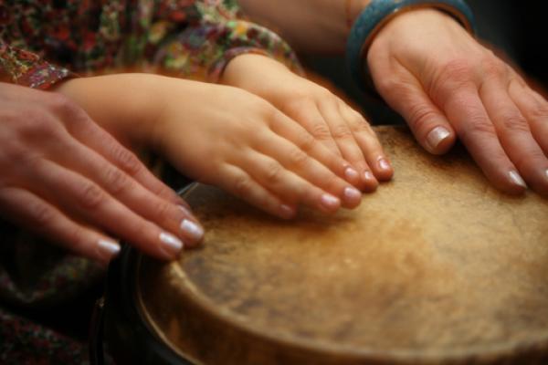 Hands of music teacher and student, Anna Jurkovska / Shutterstock.com