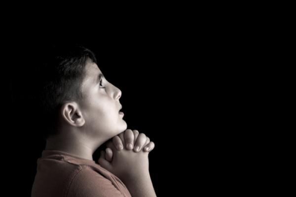 Portrait of a boy praying, Emin Ozkan / Shutterstock.com