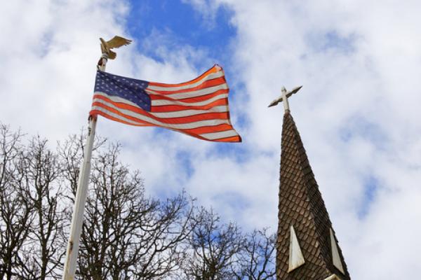American flag and church steeple, Bobkeenan Photography / Shutterstock.com