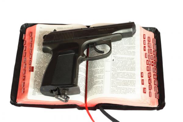 Religion and gun photo,  sagasan / Shutterstock.com