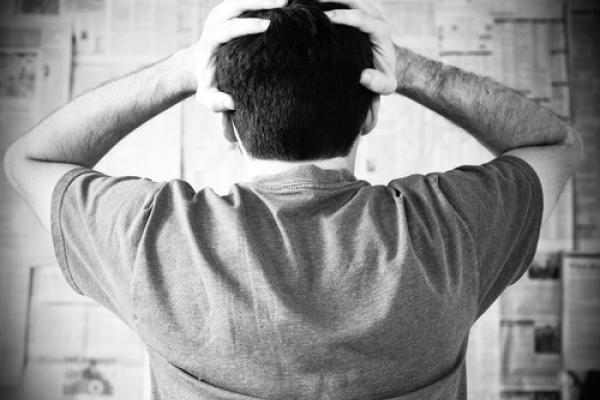 Man overwhelmed by bad news, Joyce Vincent / Shutterstock.com