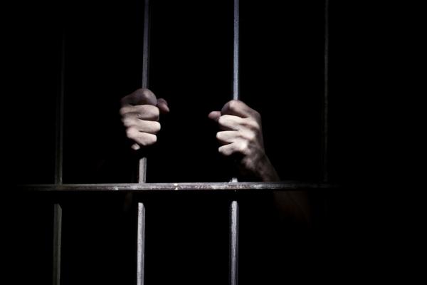 Hands of a prisoner | BortN66, Shutterstock.com.