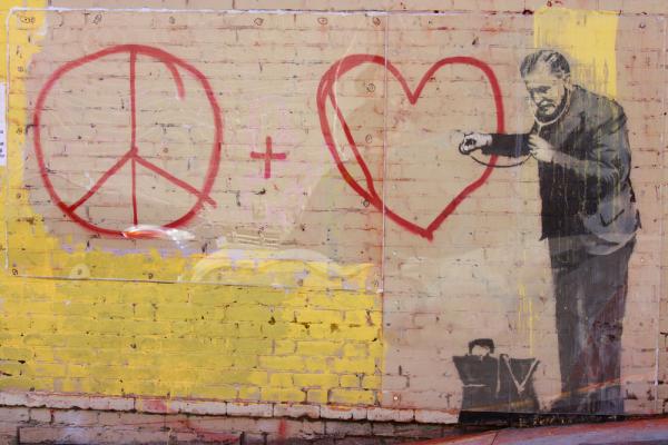 Banksy stencil grafitti in San Francisco. Radoslaw Lecyk / Shutterstock.com