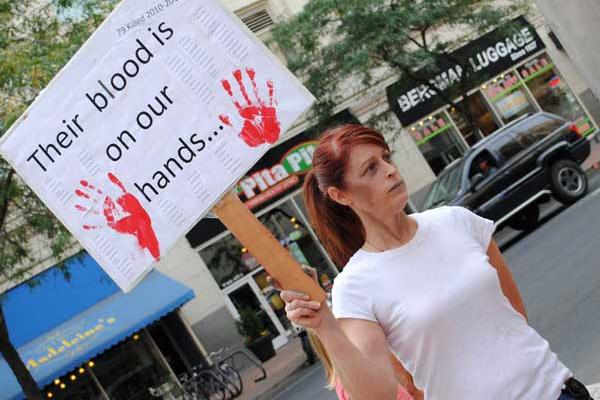 Victoria Ann Thorpe protests against the death penalty outside of a Spokane mall