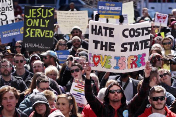 Demonstrators gather to protest the religious freedom bill signed by Gov. Mike P