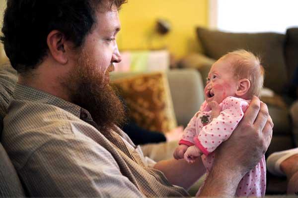 Eric Brown holds his two-month-old daughter, Pearl Joy, on Oct. 1, 2012. 