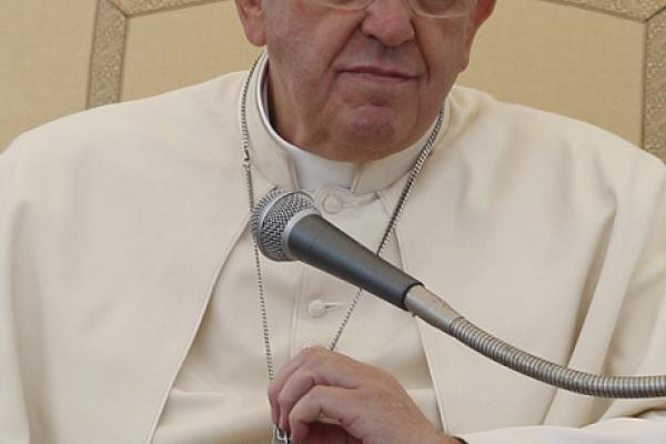 Pope Francis holds his pectoral cross.  Photo via Paul Haring / Catholic News Se