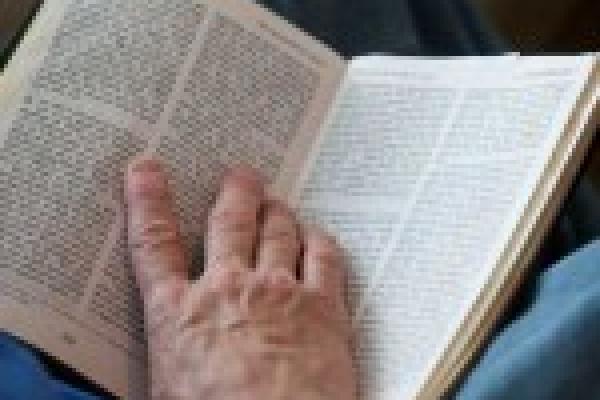 Reading the Bible. Image via RNS.