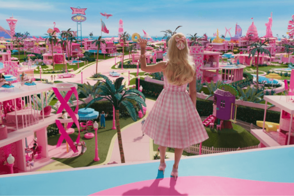 Barbie wears a pink dress and looks out over Barbieland