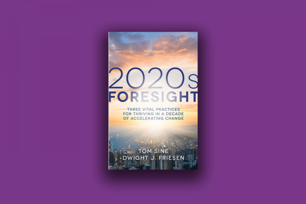 The cover of the book "2020s Foresight" shows the sky at sunrise and a city beneath it.